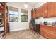 Office space featuring wood built-ins, cabinets, a desk, and two windows for natural light at 3554 N Hooper St, Buckeye, AZ 85396