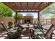 Outdoor fireplace and pergola offer a relaxing outdoor space with comfortable seating at 3554 N Hooper St, Buckeye, AZ 85396