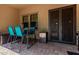 Outdoor patio with seating, grill, and secure decorative iron door offers easy indoor-outdoor living at 3554 N Hooper St, Buckeye, AZ 85396
