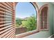 A beautiful arched window showing golf course and mountain views at 3554 N Hooper St, Buckeye, AZ 85396