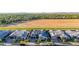 Beautiful aerial shot of neighborhood homes with gray roofs and large empty field in the background at 3684 E Boot Track Trl, Gilbert, AZ 85296