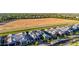 Stunning aerial view of gray roofed single Gathering homes and a large empty field on a sunny day at 3684 E Boot Track Trl, Gilbert, AZ 85296