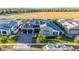 Expansive aerial view of a home with gray roofs, 3-car garage, and a boat parked out front at 3684 E Boot Track Trl, Gilbert, AZ 85296