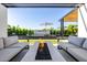 Backyard oasis featuring a modern fire pit, comfortable seating, and a sleek water feature at 3684 E Boot Track Trl, Gilbert, AZ 85296