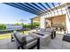 Relaxing backyard with a fire pit, elegant water feature, and modern patio furniture at 3684 E Boot Track Trl, Gilbert, AZ 85296