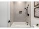 Bathroom with a shower/tub combo, modern fixtures, and neutral tile at 3684 E Boot Track Trl, Gilbert, AZ 85296