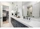 Primary bathroom featuring double sinks, marble countertop, and modern faucets at 3684 E Boot Track Trl, Gilbert, AZ 85296