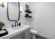 Stylish powder room featuring modern fixtures, marble countertop, and decorative accents at 3684 E Boot Track Trl, Gilbert, AZ 85296