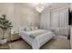 Cozy bedroom featuring a bed, chandelier, white walls, neutral tones, and a crib at 3684 E Boot Track Trl, Gilbert, AZ 85296
