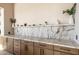 Modern built-in shelving unit with warm wood cabinets and marble countertops at 3684 E Boot Track Trl, Gilbert, AZ 85296