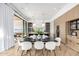 Elegant dining room featuring sleek black dining table with seating for six, light wood cabinets, and hardwood flooring at 3684 E Boot Track Trl, Gilbert, AZ 85296