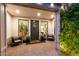 Inviting entryway with elegant seating, decorative wreath, and lush greenery for a warm welcome at 3684 E Boot Track Trl, Gilbert, AZ 85296