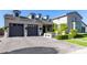 Front exterior daytime view with garage doors, entrance, and landscaping at 3684 E Boot Track Trl, Gilbert, AZ 85296