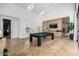 Bright game room featuring a pool table, wood floors, high ceilings, and custom built-ins at 3684 E Boot Track Trl, Gilbert, AZ 85296