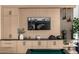 Close up of custom built-in featuring cabinets, shelving, decor, and a mounted television at 3684 E Boot Track Trl, Gilbert, AZ 85296