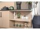 Close up of custom shelving unit with decorative items and a book with the words Eat Well, Drink Well, and Travel Often at 3684 E Boot Track Trl, Gilbert, AZ 85296