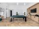 Bright game room featuring a pool table, wood floors, high ceilings, and custom built-ins at 3684 E Boot Track Trl, Gilbert, AZ 85296