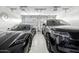 Spacious garage with epoxy flooring showcasing two luxury vehicles under bright lighting with a modern aesthetic at 3684 E Boot Track Trl, Gilbert, AZ 85296