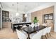 Well-lit kitchen and dining area showcasing a sleek island, pendant lights, and a modern dining table set at 3684 E Boot Track Trl, Gilbert, AZ 85296