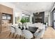 Elegant living room with fireplace, hardwood floors, and dining space, showcasing an open-concept layout at 3684 E Boot Track Trl, Gilbert, AZ 85296