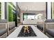 An open indoor/outdoor living space with a modern fireplace, comfortable seating, and a seamless transition to the outdoors at 3684 E Boot Track Trl, Gilbert, AZ 85296