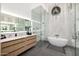 Stunning main bathroom with wood cabinets, marble countertops, glass shower, and standalone tub with a chandelier at 3684 E Boot Track Trl, Gilbert, AZ 85296