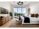 Serene main bedroom with backyard views, modern lighting, and wood furnishings at 3684 E Boot Track Trl, Gilbert, AZ 85296