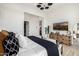 Spacious and modern main bedroom featuring an entertainment center, hardwood floors, and bright white walls at 3684 E Boot Track Trl, Gilbert, AZ 85296