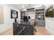 Office with a large custom desk, built-in bookshelves, and modern decor at 3684 E Boot Track Trl, Gilbert, AZ 85296