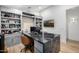 Home office featuring custom built-in cabinets and an executive style desk at 3684 E Boot Track Trl, Gilbert, AZ 85296