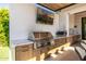 Modern outdoor kitchen featuring a BBQ, pizza oven, and custom cabinetry at 3684 E Boot Track Trl, Gilbert, AZ 85296