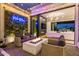 Outdoor living area with inviting fire pit, cozy seating, a neon sign and an open view to interior at 3684 E Boot Track Trl, Gilbert, AZ 85296