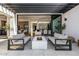Stylish outdoor patio with comfortable seating around a modern fire pit, opening to the home's interior at 3684 E Boot Track Trl, Gilbert, AZ 85296