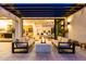 Inviting patio with an outdoor fireplace, comfortable seating, and seamless indoor-outdoor living at 3684 E Boot Track Trl, Gilbert, AZ 85296