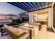 Stylish outdoor patio with a cozy fire pit, comfortable seating, and views of the pool at 3684 E Boot Track Trl, Gilbert, AZ 85296
