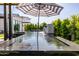 Stunning pool featuring elegant design and a soothing water feature amidst manicured greenery at 3684 E Boot Track Trl, Gilbert, AZ 85296