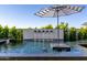 Luxurious pool area featuring multiple fountains and stylish sun umbrellas at 3684 E Boot Track Trl, Gilbert, AZ 85296