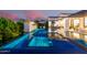 Stunning outdoor pool with water features, umbrellas and poolside living with outdoor kitchen at 3684 E Boot Track Trl, Gilbert, AZ 85296