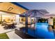 Inviting backyard pool area featuring a dining set and fire pit under a wooden pergola at 3684 E Boot Track Trl, Gilbert, AZ 85296