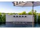 This outdoor pool features an eye-catching water feature, complemented by an umbrella for a relaxing poolside experience at 3684 E Boot Track Trl, Gilbert, AZ 85296