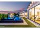 Beautiful backyard pool area with fire pit, lounge chairs, and seamless transition to the home interior at 3684 E Boot Track Trl, Gilbert, AZ 85296