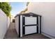A white and black shed is located on the side of the home's exterior at 3684 E Boot Track Trl, Gilbert, AZ 85296