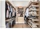 Organized walk-in closet with custom shelving, hanging racks, and storage solutions for clothing and accessories at 3684 E Boot Track Trl, Gilbert, AZ 85296