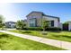 Lush front yard features a vibrant lawn, young trees, trimmed hedges and a sidewalk at 3684 E Boot Track Trl, Gilbert, AZ 85296