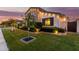 Side yard featuring manicured hedges, decorative lighting, and a vibrant green lawn at 3684 E Boot Track Trl, Gilbert, AZ 85296