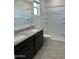 Bathroom featuring double sinks, granite countertops, and shower at 38055 W Excussare Way, Maricopa, AZ 85138