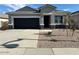 Charming single story home with a well-maintained gravel yard and a two car garage at 38055 W Excussare Way, Maricopa, AZ 85138