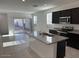 Contemporary kitchen featuring stainless steel appliances, stone countertops, and an island at 38055 W Excussare Way, Maricopa, AZ 85138