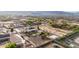 Panoramic aerial view captures the home's backyard with pool, desert landscape and community at 3911 N 197Th Ave, Buckeye, AZ 85396