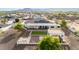 Aerial view featuring the home's manicured backyard, solar panels, covered patio and desert landscaping at 3911 N 197Th Ave, Buckeye, AZ 85396